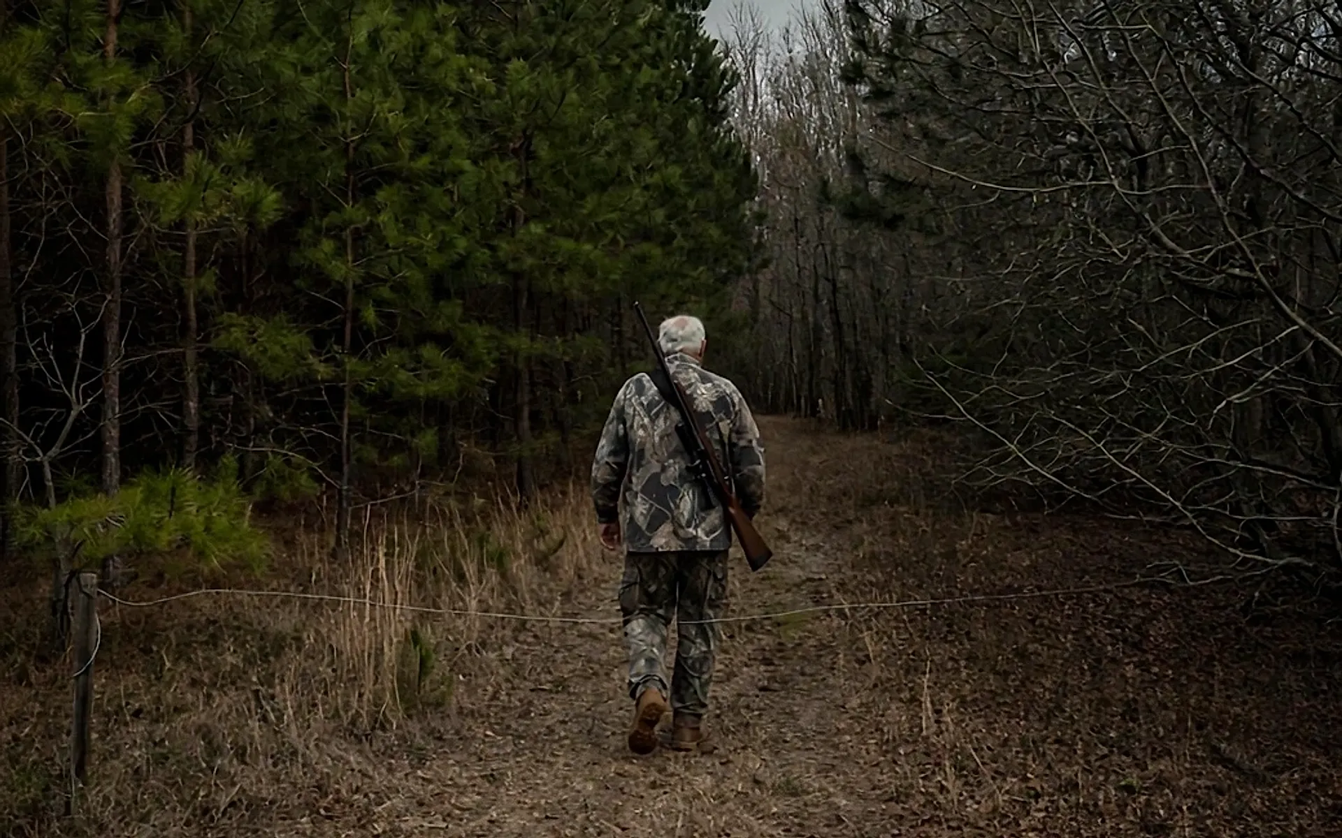 Mickey Herring walking into the clearing on his land at Cooter Road